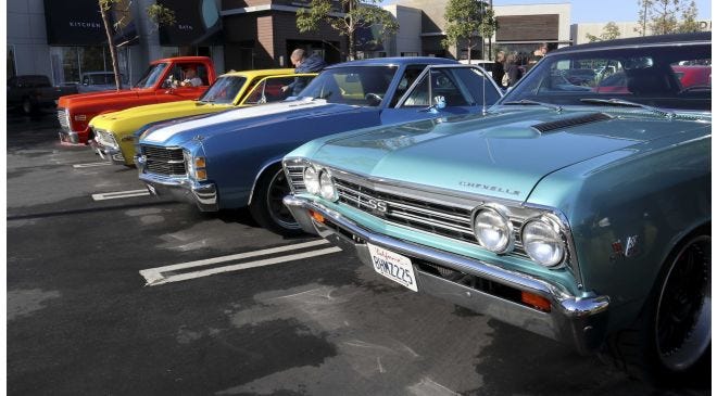 Participants enjoying Quarantine Cruise 11 car show event.