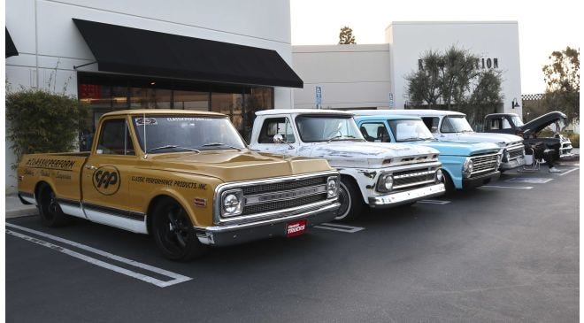 Classic cars at Quarantine Cruise 13 with large crowd.