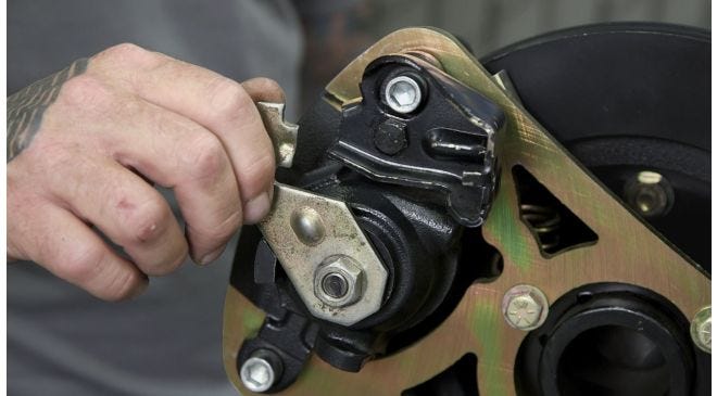 Detailed view of Cadillac caliper parking brake adjustment